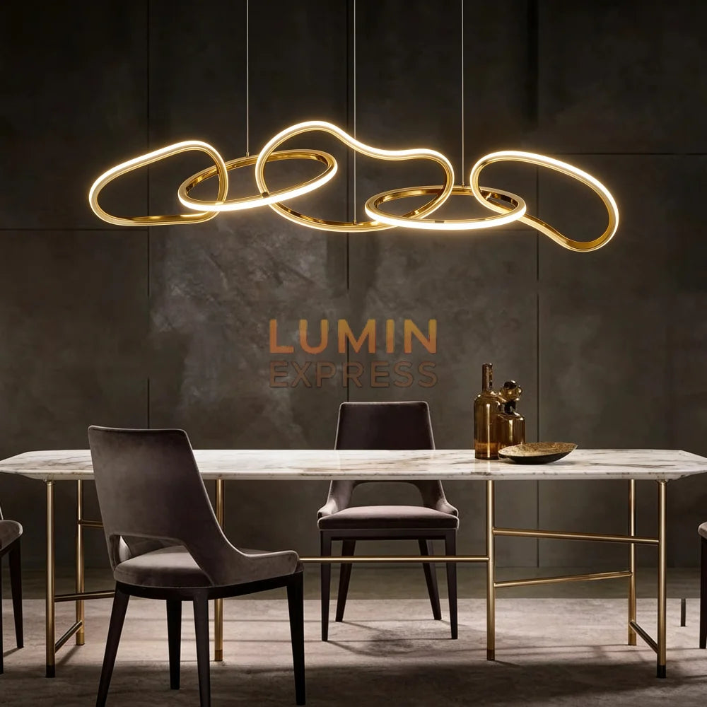 Lustre Monaco doré en acier inoxydable avec design ondulé moderne et éclairage LED intégré, suspension contemporaine élégante au-dessus d’une table à manger